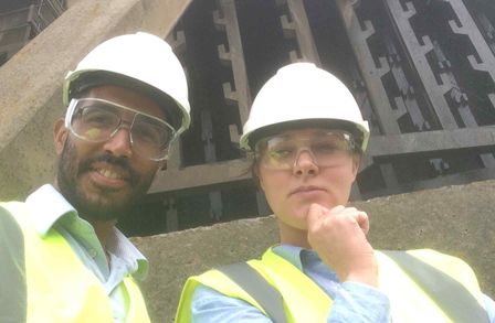 Anna and Franky positing in front of a cooling tower