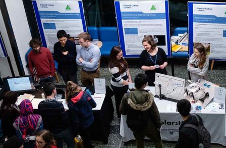 A photo looking down at the outreach interactions between visitors and researchers at their stalls
