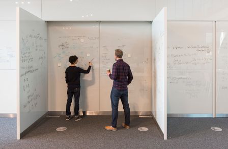 Two academics at a whiteboard