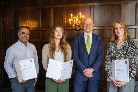 Provost Ian Walmsley standing with the winners who are holding their certificates