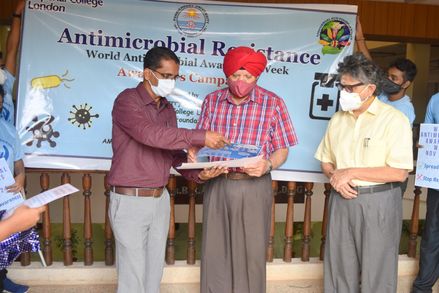 Principal Investigator Professor Joseph Selvin with the vice chancellor of Pondicherry University- Gurmeet Singh. Joseph is showing Gurmeet materials related to AMR awareness.