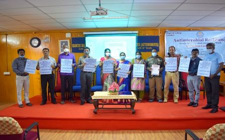 Participants of the AMR awareness week stand on a stage at Pondicherry University, after giving awareness talks