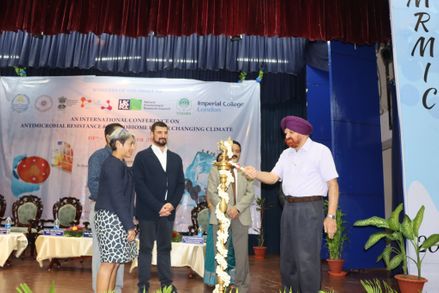 Prof Shiranee Sriskandan and Prof Nick Voulvoulis watch as Vice Chancellor Gurmeet Singh lights the inaugural lamp