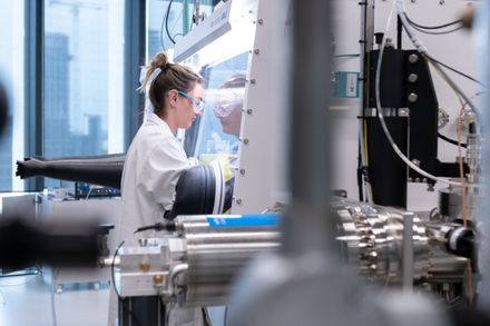 A lady wearing a lab coat in a lab