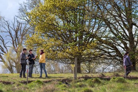 three students standing in open green space at Silwood Campus