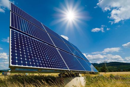 Figure shows a solar panel in a green field.