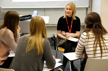 Four women talking in a workshop