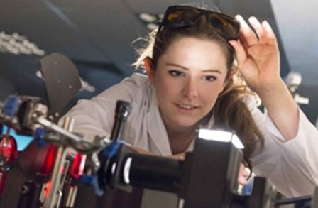 Woman looking at a piece of lab machinery