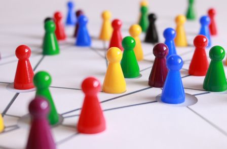 Colourful Ludo board game pieces on a board