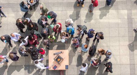 Top down view of crowd around demonstration table