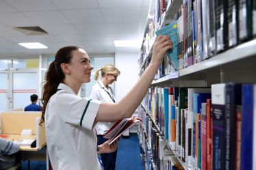 Users searching the bookshelves at Chelsea and Westminster Medical Library