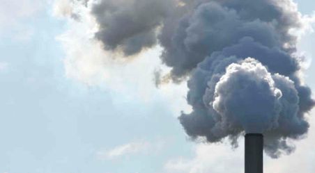 Industrial chimney spouting plumes of thick smoke