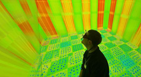 A male student using a virtual reality headset to experience a 3D representation of a nuclear reactor core