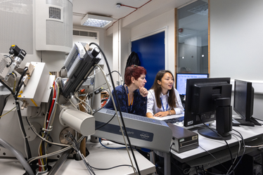 Two female researchers looking at a computer screen