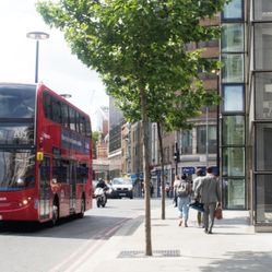 A bus in London and people walking by
