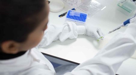 Researcher in laboratory pipetting