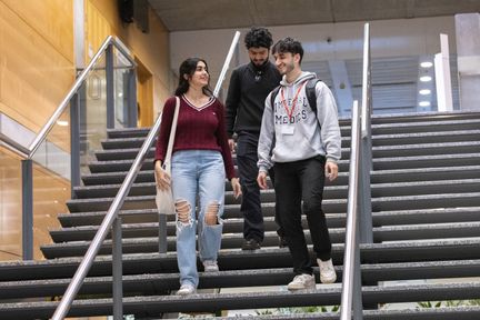 Undergraduate students walking down some stairs