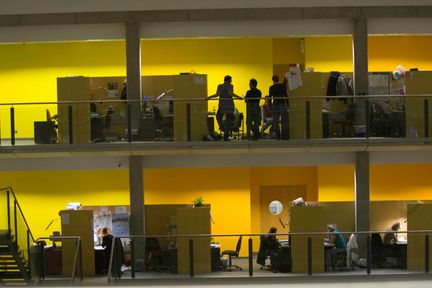 Researchers work and chat in the atrium levels of the Sir Alexander Fleming Building at South Kensington campus