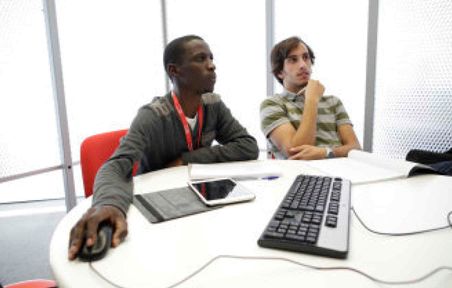 Students using a computer in Library study space