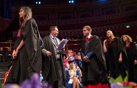 A staff member working at graduation