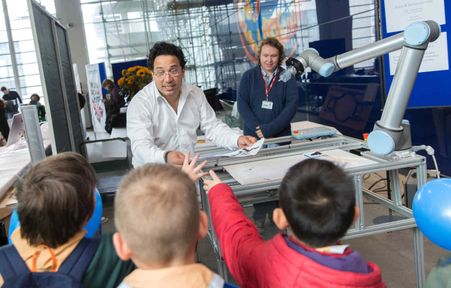 Two Imperial researchers demonstrate a robot at Imperial Festival
