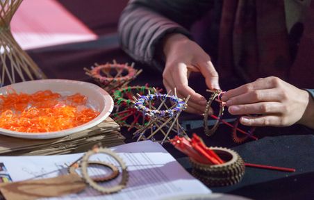 Close up of person's hands making a small structure