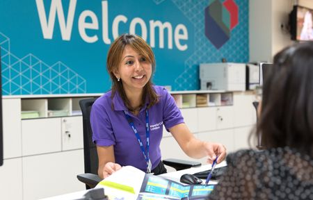 Staff talking to student at the Student Support hub