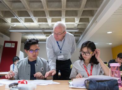 Students at a workshop with a staff member