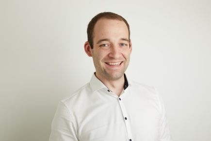 Portrait of Dr Evgeniy Donchev, Entrepeneur's Pledger, smiling at the camera against a white background