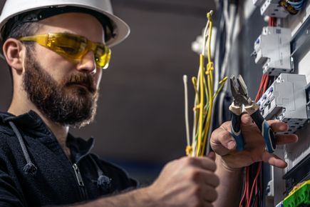 An electrician working with wires and cutting pliers