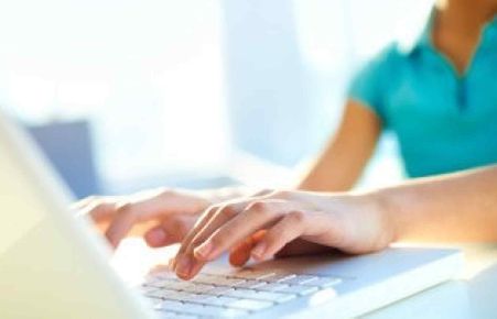 Person typing on a laptop keyboard