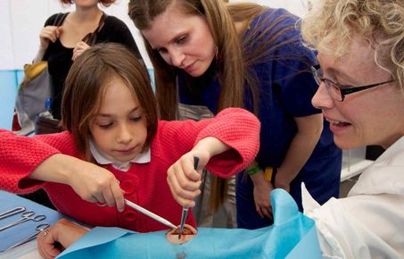 girl stitching up artificial wound