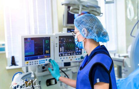 A female healthcare professional operating a ventilator