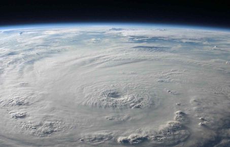 Image of part of the earth's surface from space showing swirling clouds