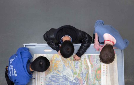 Students looking at a large map