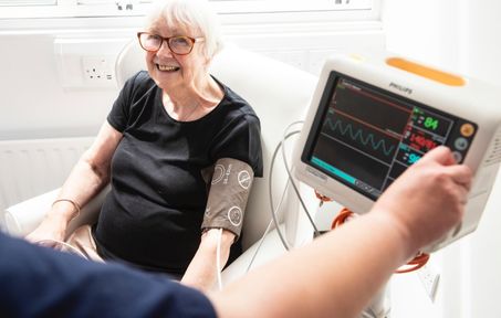 Woman smiling having blood pressure taken