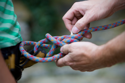 Close-up of a harness being tied for a climbing wall