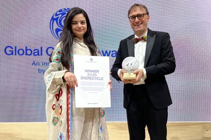Two people receiving an award