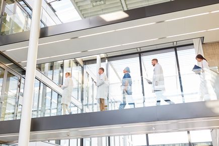 A picture of nurses and doctors walking across a walkway