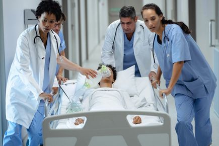 A picture of doctors and nurses and a patient