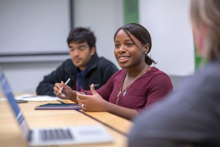 A student takes part in a discussion during a class