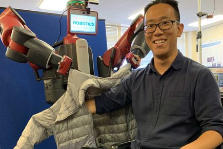 Researcher demonstrates Personal Robotics Lab assisted dressing robot