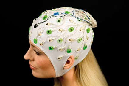 a woman wearing an EEG cap with sensors