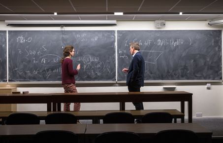 Student and professor in front of blackboard