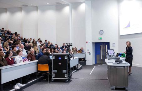 Woman giving a talk in a lecture theatre