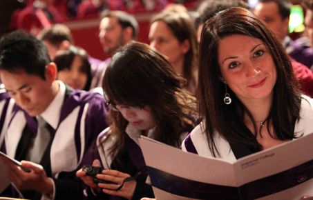 Three graduands sat eagerly await the presentation of their certificates in the auditorium at the Royal Albert Hall
