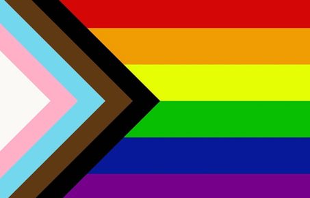 Inclusive rainbow pride flag including colours of the trans flag and brown and black stripes to represent people of colour