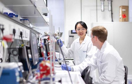 Two students having a conversation in a lab