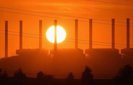 A power station and line of chimneys at sunset