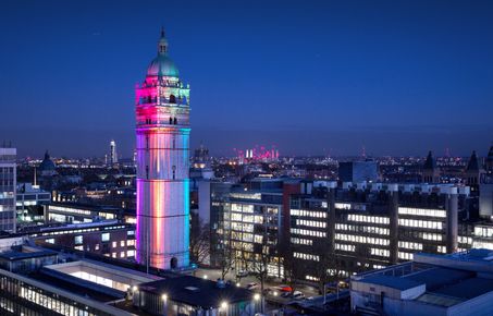Queens Tower at South Kensington Campus lit up for lgbtq month